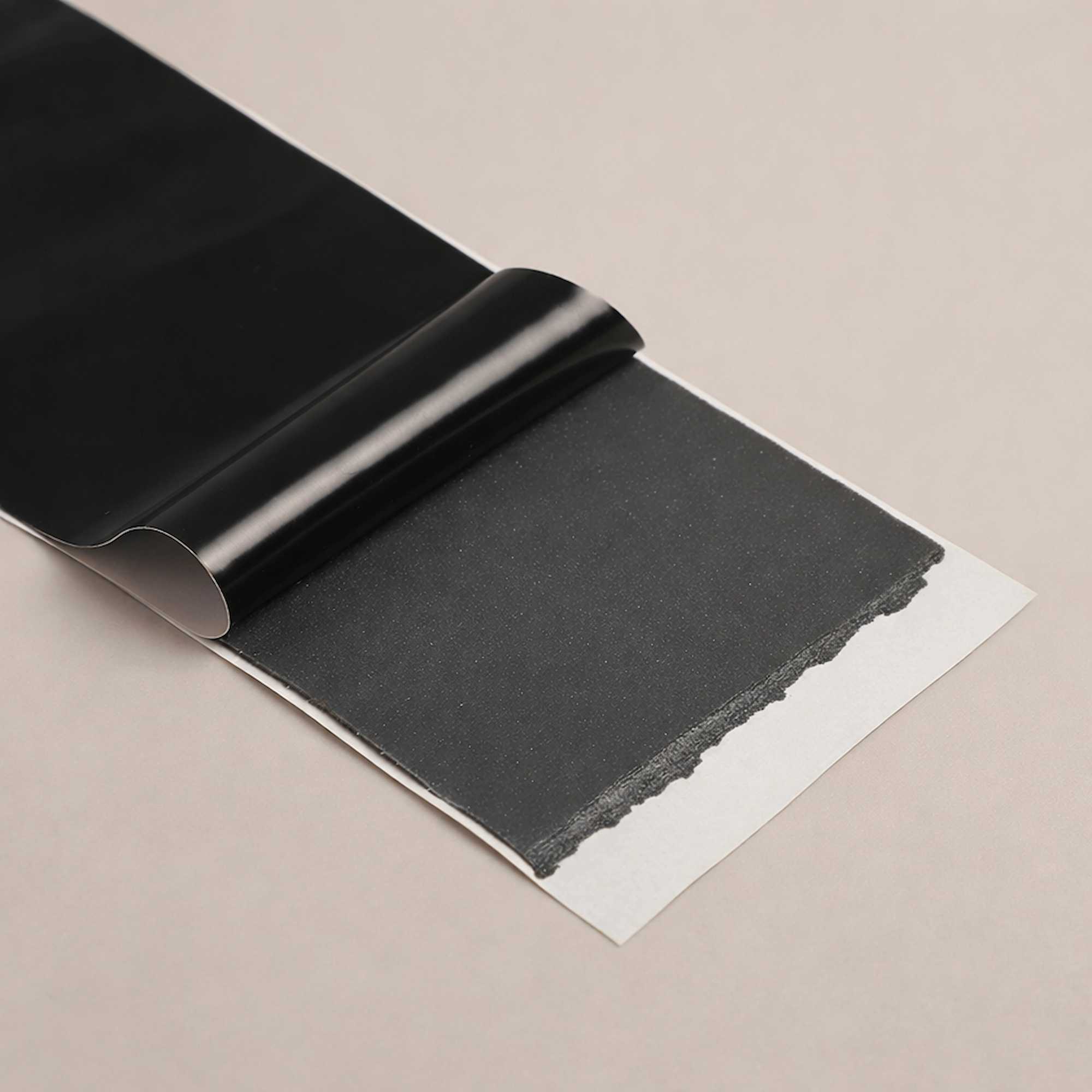 Close-up of butyl adhesive layer on window and door flashing tape